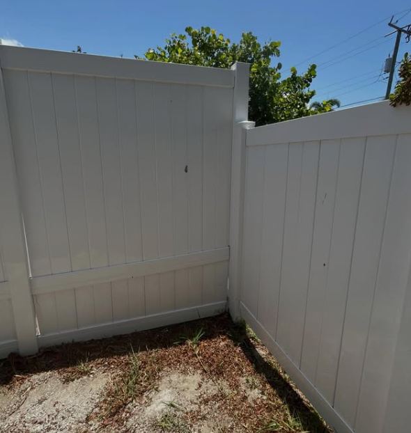Same fence bright white after pressure washing