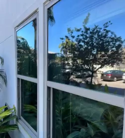 Streak-free residential window glass reflecting the yard